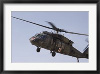 Framed UH-60 Blackhawk Medivac helicopter flies over Camp Warhorse