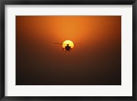 Framed AH-64D Apache Helicopter Flying into the Sun over Iraq