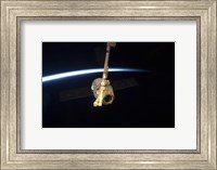 Framed SpaceX Dragon Cargo Craft with Earth's Horizon in the Background