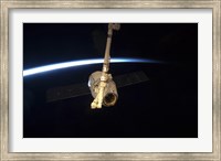 Framed SpaceX Dragon Cargo Craft with Earth's Horizon in the Background