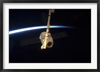 Framed SpaceX Dragon Cargo Craft with Earth's Horizon in the Background