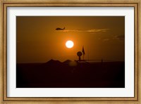 Framed UH-60 Blackhawk Flies Over Camp Speicher Airfield at Sunset