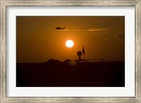 Framed UH-60 Blackhawk Flies Over Camp Speicher Airfield at Sunset