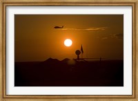 Framed UH-60 Blackhawk Flies Over Camp Speicher Airfield at Sunset