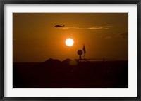 Framed UH-60 Blackhawk Flies Over Camp Speicher Airfield at Sunset