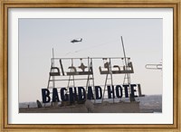 Framed AH-64 Apache in flight over the Baghdad Hotel in central Baghdad, Iraq