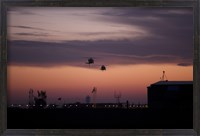 Framed pair of UH-60 Black Hawk helicopters approach their Landing in Baghdad, Iraq