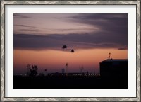 Framed pair of UH-60 Black Hawk helicopters approach their Landing in Baghdad, Iraq