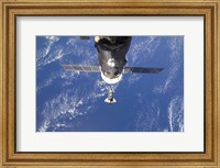 Framed Space Shuttle Discovery approaches the International Space Station