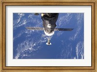 Framed Space Shuttle Discovery approaches the International Space Station