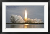 Framed Space shuttle Atlantis lifts off from the Kennedy Space Center, Florida