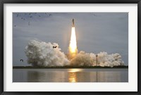 Framed Space shuttle Atlantis lifts off from the Kennedy Space Center, Florida