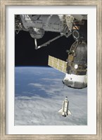 Framed Space Shuttle Endeavour, a Soyuz Spacecraft, and the International Space Station