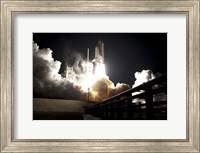 Framed Space Shuttle Endeavour lifts off into the Night Sky from Kennedy Space Center