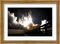 Framed Space Shuttle Endeavour lifts off into the Night Sky from Kennedy Space Center