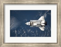 Framed Aerial view of Space Shuttle Discovery over Earth