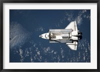 Framed Aerial view of Space Shuttle Discovery over Earth