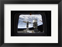 Framed Two Russian Spacecraft Docked with the International Space Station, as seen from Space Shuttle Discovery's Flight Deck Window
