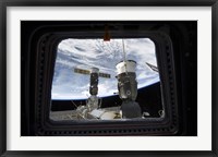 Framed Two Russian Spacecraft Docked with the International Space Station, as seen from Space Shuttle Discovery's Flight Deck Window