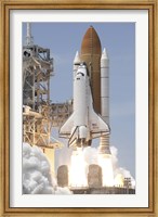 Framed Space Shuttle Atlantis' Twin Solid Rocket Boosters Ignite to Propel the Spacecraft off Kennedy Space Center's Launch Pad 39A