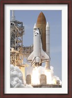 Framed Space Shuttle Atlantis' Twin Solid Rocket Boosters Ignite to Propel the Spacecraft off Kennedy Space Center's Launch Pad 39A