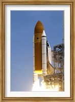 Framed Atlantis' Twin Solid Rocket Boosters Ignite to Propel the Spacecraft Off Kennedy Space Center's Launch Pad 39A
