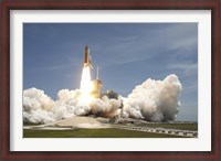 Framed Space shuttle Atlantis rumbles the Space Coast as it lifts off from Kennedy Space Center's Launch Pad 39A