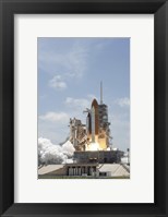 Framed Space shuttle Atlantis lifts off