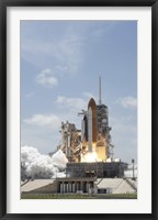 Framed Space shuttle Atlantis lifts off