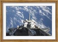 Framed partial view of Space Shuttle Atlantis Backdropped by a Blue and White Earth