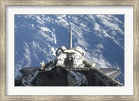 Framed partial view of Space Shuttle Atlantis Backdropped by a Blue and White Earth