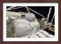 Framed Pressurized Mating Adapter 3 in the Grasp of the Canadarm2