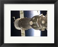 Framed Soyuz spacecraft backdropped by Earth