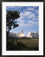 Framed Space Shuttle Atlantis lifts off from its Launch Pad at Kennedy Space Center, Florida