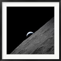 Framed crescent Earth Rises above the Lunar Horizon