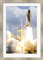 Framed Space Shuttle Atlantis lifts off from its Launch Pad toward Earth Orbit