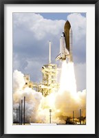 Framed Space Shuttle Atlantis lifts off from its Launch Pad toward Earth Orbit