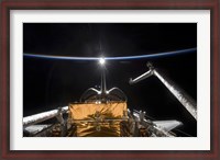 Framed Space Shuttle Atlantis' Payload Bay Backdropped by a Blue and White Earth