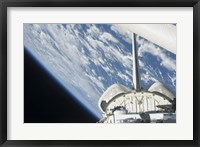 Framed Partial view of Space Shuttle Endeavour Backdropped against Earth