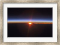 Framed Layers of Earth's atmosphere, brightly colored as the sun sets over South America