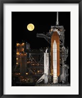 Framed Nearly full Moon Sets as Space Shuttle Discovery Sits Atop the Launch Pad