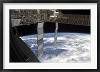 Framed International Space Station Backdropped Againts a Blue and White Earth