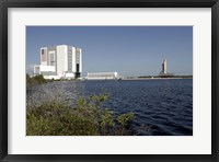 Framed Viewed across the Basin, Space Shuttle Atlantis Crawls Toward the Launch Pad