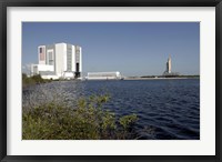 Framed Viewed across the Basin, Space Shuttle Atlantis Crawls Toward the Launch Pad