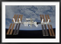 Framed International Space Station, Backdropped by the blackness of space and Earth's horizon