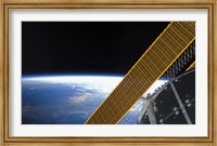 Framed Solar array Panels on the International Space Station Backdropped Against Earth's Horizon