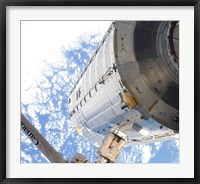 Framed Kibo Japanese Pressurized Module in the Grasp of the Robotic Canadarm2