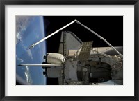 Framed Soyuz Vehicle and the Space Shuttle Discovery Docked to the International Space Station