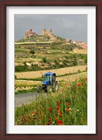 Framed Blue tractor on rural road, San Vicente de la Sonsierra Village, La Rioja, Spain