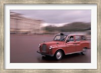 Framed Cab racing past Buckingham Palace, London, England